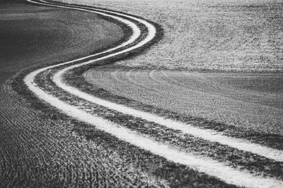 High angle view of tire tracks on road