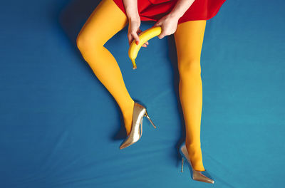 Low section of woman wearing high heels