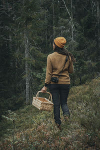 Woman picking mushrooms in forest