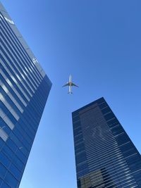 Low angle view of skyscraper against clear blue sky