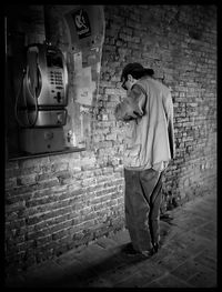 Man standing against wall