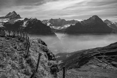 Scenic view of mountains against cloudy sky