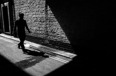 Rear view of man walking on street