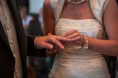 Midsection of couple holding hands