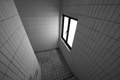 High angle view of staircase with tile walls in building