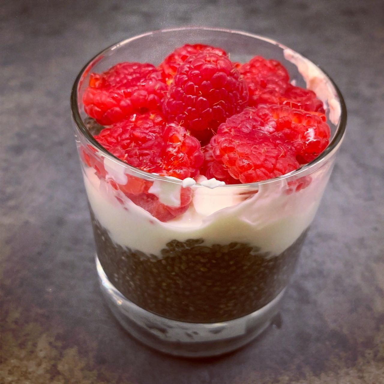 CLOSE-UP OF STRAWBERRIES ON GLASS TABLE