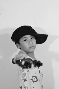 Portrait of boy standing against wall