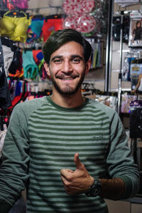 Portrait of smiling young man standing in store