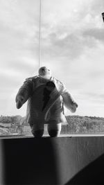 Low angle view of boy standing against sky