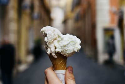 Close-up of hand holding ice cream cone