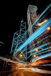 Low angle view of illuminated buildings against sky at night