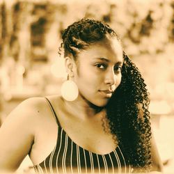 Portrait of smiling young woman with curly hair