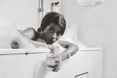 Portrait of young woman standing in bathroom