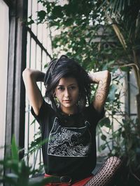 Portrait of young woman sitting outdoors