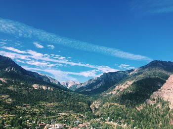 Scenic view of mountains against blue sky