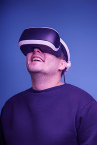 Portrait of man against blue background