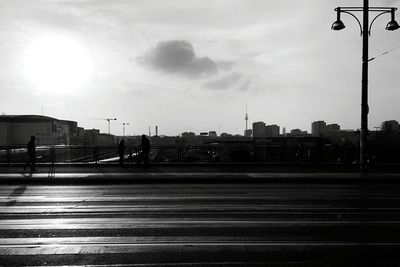 Railroad tracks against cloudy sky