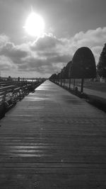 Surface level of empty footpath against sky