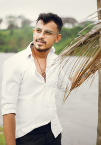 Young man wearing sunglasses standing outdoors