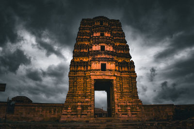 Low angle view of building against cloudy sky