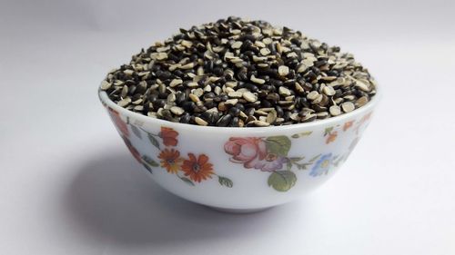 Close-up of ice cream in bowl against white background