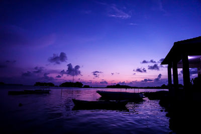 Silhouette boat in sea against sky during sunset