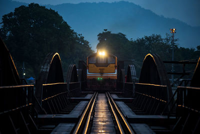 Antique train on river kwai bridge in early morning, kanchanaburi, thailand