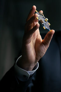 Close-up of man holding seashell