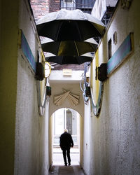 Rear view of man standing against built structure