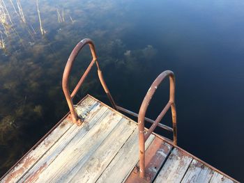 Pier by swimming pool against sky