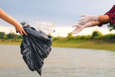 Midsection of woman holding umbrella