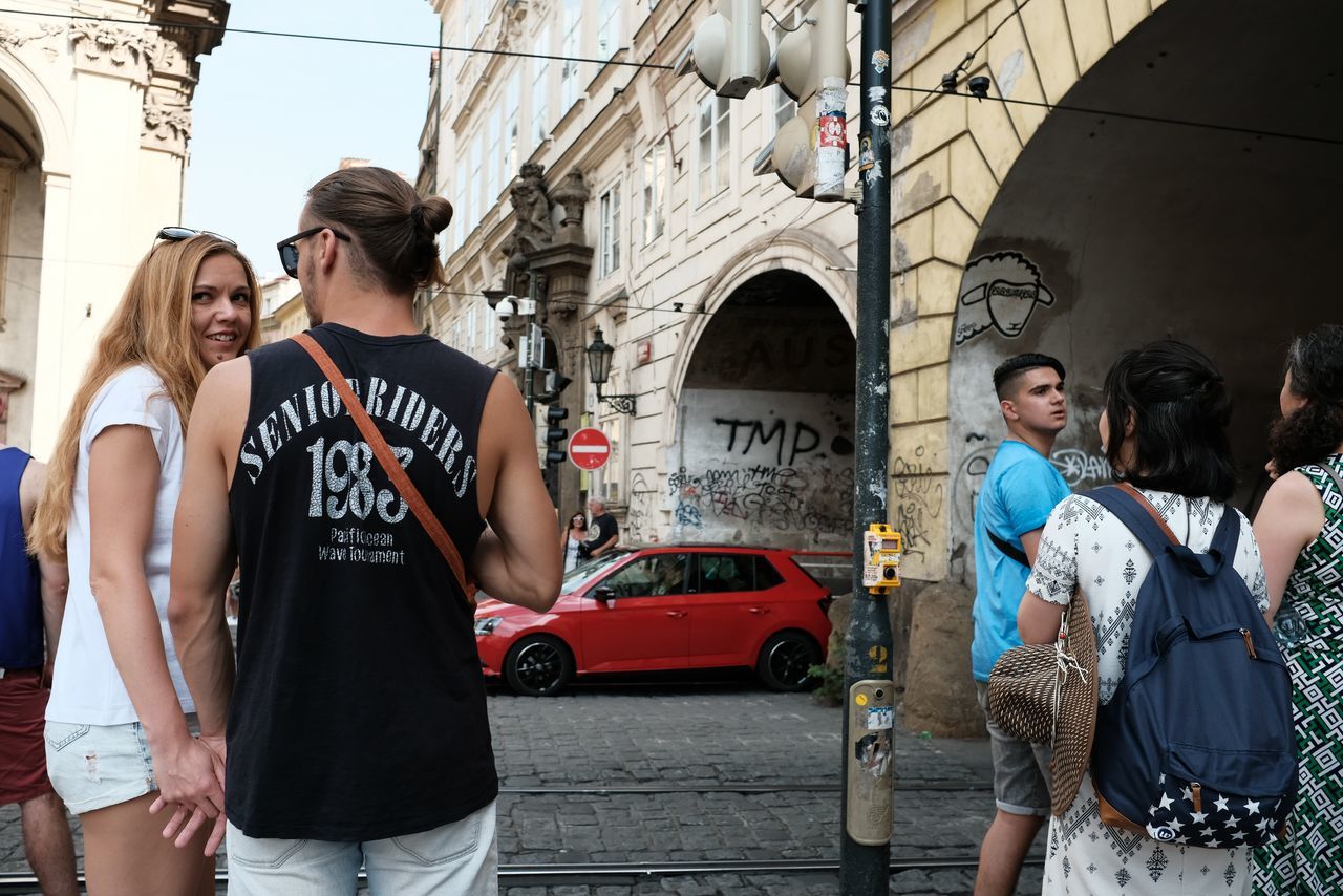 REAR VIEW OF WOMEN STANDING ON STREET