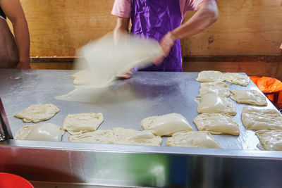 Midsection of man preparing food