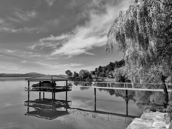 Lifeguard hut by lake against sky