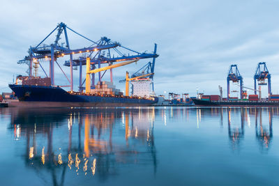 Container ship at harbor against sky