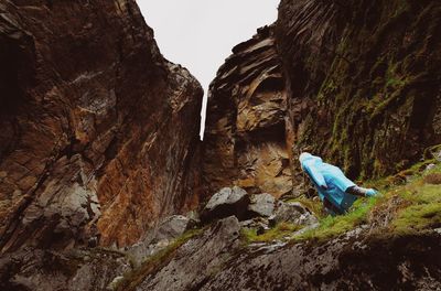 Man on cliff against mountain