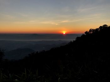 Scenic view of silhouette mountains against sky during sunset