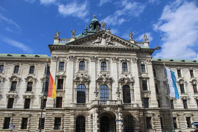 Low angle view of building against cloudy sky