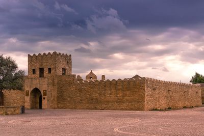 Historic building against cloudy sky