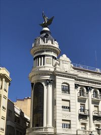 Low angle view of building against blue sky