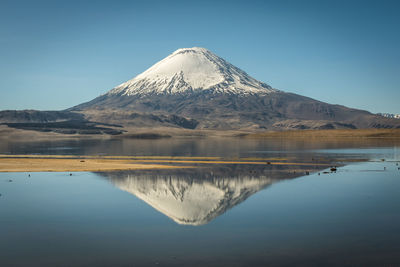 Scenic view of snowcapped mountains against clear blue sky