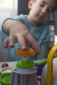 Midsection of boy playing with toy