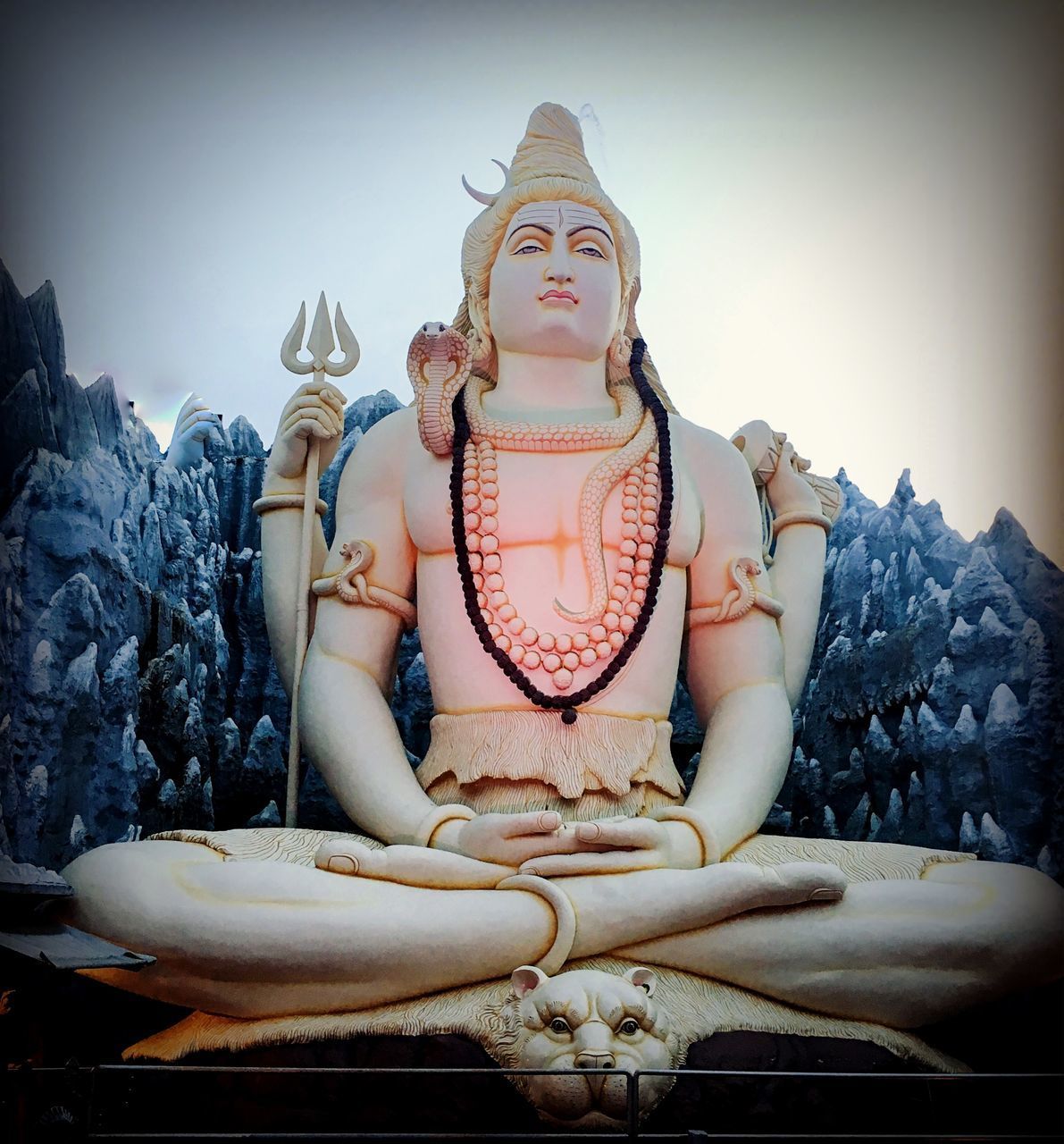 LOW ANGLE VIEW OF BUDDHA STATUE AGAINST BUILDINGS