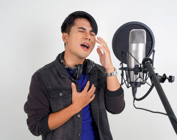 Mid adult man wearing mask against white background