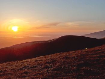 Scenic view of mountains against sky during sunset