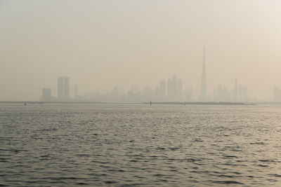 Scenic view of buildings in city against sky