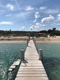 Pier over sea against sky