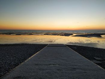 Scenic view of sea against clear sky during sunset