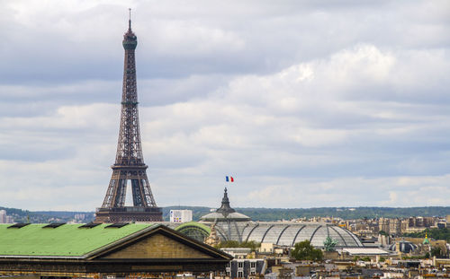 Tower of building against cloudy sky