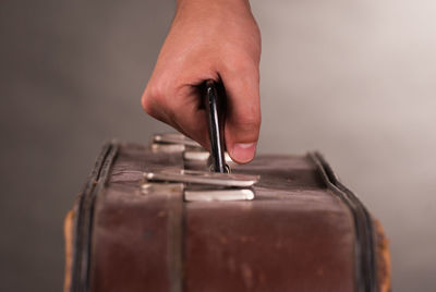 Cropped hand holding luggage